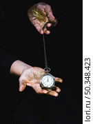 man with glitters showing pocket watch. Стоковое фото, агентство Ingram Publishing / Фотобанк Лори