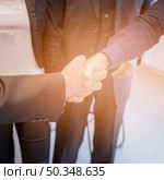 overhead view two businessman shaking hands together. Стоковое фото, агентство Ingram Publishing / Фотобанк Лори