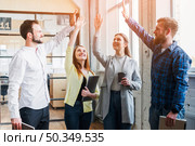 young colleagues giving high five each other. Стоковое фото, агентство Ingram Publishing / Фотобанк Лори