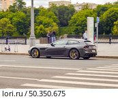 Ferrari GTC4Lusso car in motion on the road on sunny summer day in city. Редакционное фото, фотограф Константин Григорьев / Фотобанк Лори