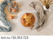 Fogaca on kitchen countertop with eggs and cinammon sticks. Traditional cake from Santa Maria da Feira, Portugal. Стоковое фото, агентство Ingram Publishing / Фотобанк Лори