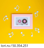 bright colorful cassette tape with musical notes around it. Стоковое фото, агентство Ingram Publishing / Фотобанк Лори