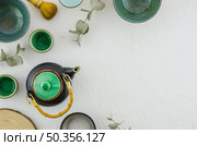 elevated view teapot bowl tea cup brush isolated white backdrop. Стоковое фото, агентство Ingram Publishing / Фотобанк Лори