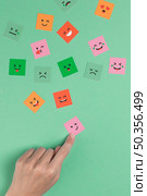 hand touching square smiling face. Стоковое фото, агентство Ingram Publishing / Фотобанк Лори