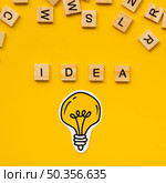 idea word from scrabble letters light bulb. Стоковое фото, агентство Ingram Publishing / Фотобанк Лори