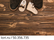male shoes near child boots. Стоковое фото, агентство Ingram Publishing / Фотобанк Лори