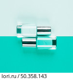 bottles teal nail polish bottles dual background. Стоковое фото, агентство Ingram Publishing / Фотобанк Лори