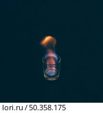 burning tequila shot glass dark background. Стоковое фото, агентство Ingram Publishing / Фотобанк Лори