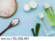 elevated view rock salts cream aloevera spray bottles blue background. Стоковое фото, агентство Ingram Publishing / Фотобанк Лори
