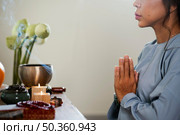 side view woman praying front candles. Стоковое фото, агентство Ingram Publishing / Фотобанк Лори