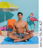 young man meditating decorative beach. Стоковое фото, агентство Ingram Publishing / Фотобанк Лори
