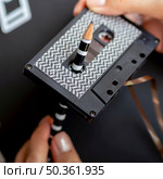 close up shot person repairing cassette tape with pencil. Стоковое фото, агентство Ingram Publishing / Фотобанк Лори