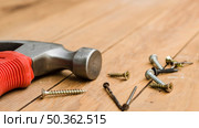 OLYMPUS DIGITAL CAMERA. hammer with self tapping screw. Стоковое фото, агентство Ingram Publishing / Фотобанк Лори