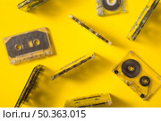 overhead view transparent audio cassette tapes colored background. Стоковое фото, агентство Ingram Publishing / Фотобанк Лори