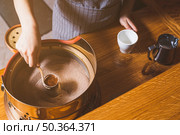 elevated view female hand making turkish coffee sand caf. Стоковое фото, агентство Ingram Publishing / Фотобанк Лори