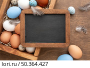 flat lay blackboard top box with eggs easter. Стоковое фото, агентство Ingram Publishing / Фотобанк Лори