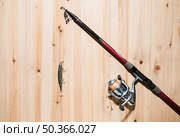 fishing lure fishing rod wooden surface. Стоковое фото, агентство Ingram Publishing / Фотобанк Лори