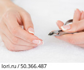 OLYMPUS DIGITAL CAMERA. manicured hands holding nail clipper. Стоковое фото, агентство Ingram Publishing / Фотобанк Лори