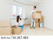 young couple after moving new home unboxing their items. Стоковое фото, агентство Ingram Publishing / Фотобанк Лори