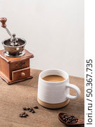 high angle coffee grinder with mug coffee beans. Стоковое фото, агентство Ingram Publishing / Фотобанк Лори