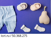 pink baby shoes sock baby s pant with stuffed pear bright blue background. Стоковое фото, агентство Ingram Publishing / Фотобанк Лори