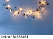 burning garland with spangles blue table. Стоковое фото, агентство Ingram Publishing / Фотобанк Лори
