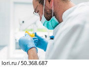 close up dentist looking dental impression clinic. Стоковое фото, агентство Ingram Publishing / Фотобанк Лори