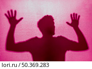 silhouette man trapped cloth. Стоковое фото, агентство Ingram Publishing / Фотобанк Лори