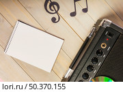 overhead view spiral notepad musical note amplifier wooden desk. Стоковое фото, агентство Ingram Publishing / Фотобанк Лори
