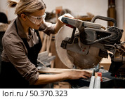 side view female carpenter with safety glasses tool. Стоковое фото, агентство Ingram Publishing / Фотобанк Лори