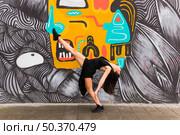 tango female dancer posing against creative graffiti wall. Стоковое фото, агентство Ingram Publishing / Фотобанк Лори