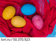 colorful easter eggs red cloth. Стоковое фото, агентство Ingram Publishing / Фотобанк Лори