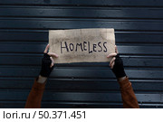 homeless sign held by beggar hands. Стоковое фото, агентство Ingram Publishing / Фотобанк Лори