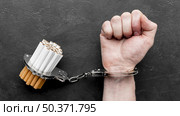 top view hand with handcuffed cigarettes. Resolution and high quality beautiful photo. top view hand with handcuffed cigarettes. High quality beautiful photo concept. Стоковое фото, агентство Ingram Publishing / Фотобанк Лори