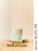 close up good morning cubic blocks with cup coffee wooden surface . Стоковое фото, агентство Ingram Publishing / Фотобанк Лори