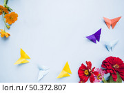 decoration with calendula marigold flowers origami paper butterflies. Стоковое фото, агентство Ingram Publishing / Фотобанк Лори