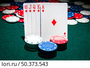 casino chips stack front royal flush playing card. Стоковое фото, агентство Ingram Publishing / Фотобанк Лори