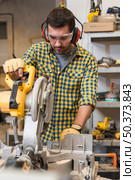 detail professional male worker using mitre saw workshop. Стоковое фото, агентство Ingram Publishing / Фотобанк Лори