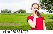pretty girl standing park having toothache. Стоковое фото, агентство Ingram Publishing / Фотобанк Лори