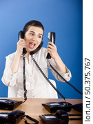 Businesswoman answering a lot of calls at the same time. Стоковое фото, агентство Ingram Publishing / Фотобанк Лори