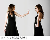 Concept about two womens disputing something - isolated on Grey. Стоковое фото, агентство Ingram Publishing / Фотобанк Лори
