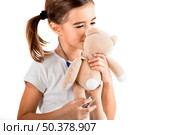 Beautiful little girl kissing her teddy-bear, isolated on white. Стоковое фото, агентство Ingram Publishing / Фотобанк Лори