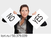 Business young woman trying to make a decision between Yes or No choice. Стоковое фото, агентство Ingram Publishing / Фотобанк Лори