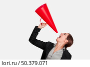 Business young woman speaking to a megaphone, isolated on white. Стоковое фото, агентство Ingram Publishing / Фотобанк Лори
