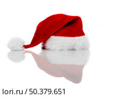 A red santa hat isolated on white with reflection. Стоковое фото, агентство Ingram Publishing / Фотобанк Лори