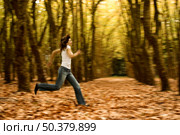 Woman runing in the Autumn Park -  Intentional blured efect. Стоковое фото, агентство Ingram Publishing / Фотобанк Лори