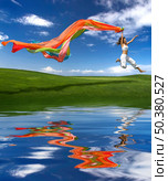 Young beautiful woman jumping with a scarf (reflection made in PS) Стоковое фото, агентство Ingram Publishing / Фотобанк Лори