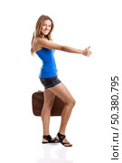 Beautiful young woman hitch hiking with old leather suitcase, isolated on white. Стоковое фото, агентство Ingram Publishing / Фотобанк Лори