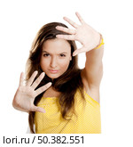 Beautiful young girl with both hands on the air, isolated on white. Стоковое фото, агентство Ingram Publishing / Фотобанк Лори