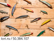 colorful fishing lures wooden desk. Стоковое фото, агентство Ingram Publishing / Фотобанк Лори